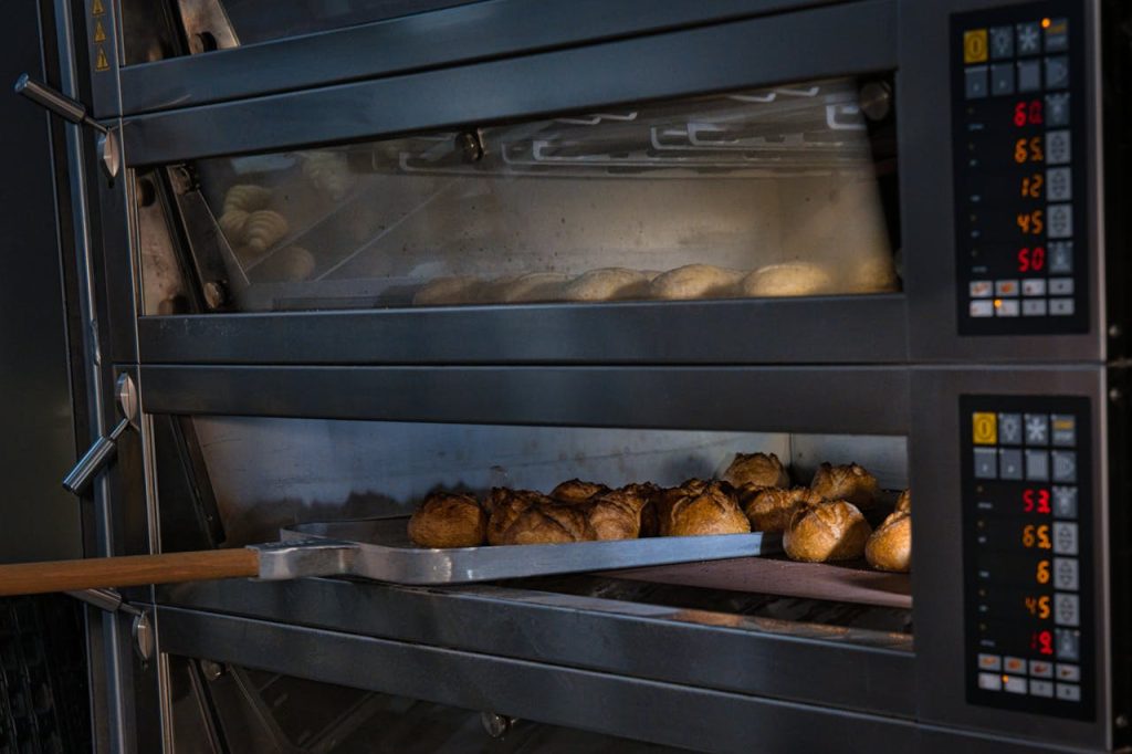 Artisan bread baking in a professional oven at a Berlin bakery, showcasing traditional baking techniques.